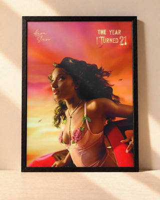 Poster Ayra Starr – The Year I Turned 21 encadré dans un cadre noir, posé contre un mur clair