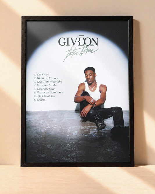 Poster Giveon – Take Time encadré dans un cadre noir, posé contre un mur clair